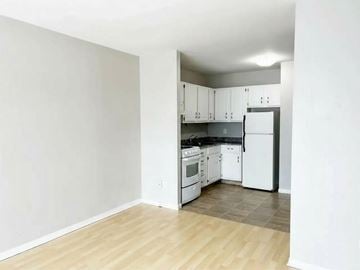 Moncton apartment for rent - A kitchen with white appliances and wooden floors.
