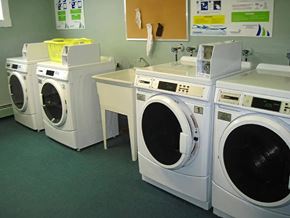 Moncton apartment for rent - A row of washing machines in a laundromat.