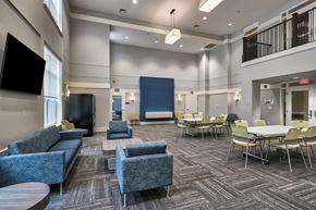 Suitland apartment for rent - A conference room with a blue carpet and chairs.