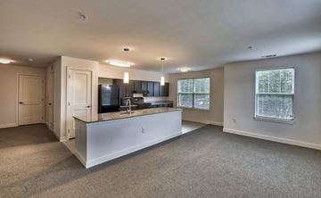 Suitland apartment for rent - A spacious kitchen with a white island and a window.