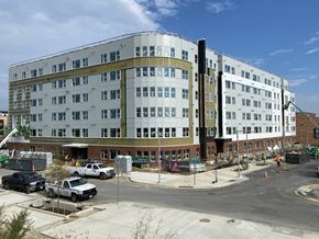 Suitland apartment for rent - A large white building with a green roof is under construction.