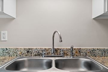 Summerville apartment for rent - A kitchen sink with a chrome faucet and a granite countertop.