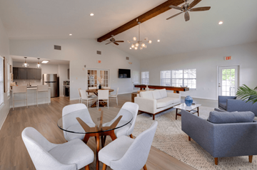 Savannah apartment for rent - A modern living room with a glass table surrounded by white chairs.