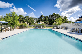 Savannah apartment for rent - A large swimming pool surrounded by trees and a fence at Retreat at Savannah Apartments, Savannah, Georgia