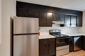 Savannah apartment for rent - A kitchen with a stainless steel refrigerator and black cabinets at Savan Pointe Apartments, Savannah, Georgia