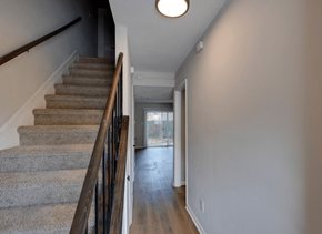 Savannah apartment for rent - A staircase with a carpeted runner and wooden banister at Savan Pointe Apartments, Georgia