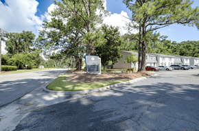 Savannah apartment for rent - A sign in front of a building with trees around it at Savan Pointe Apartments, Savannah 31406