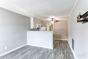 Perry apartment for rent - A room with a television mount and a ceiling fan.