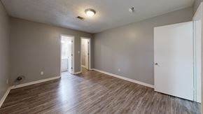 Hawkinsville apartment for rent - A room with wooden flooring and white walls.
