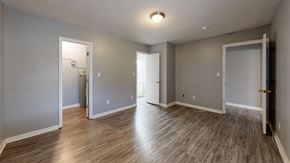 Hawkinsville apartment for rent - A room with wooden flooring and three open doors.