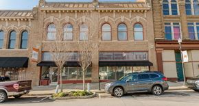 Macon apartment for rent - A tree in front of a building with a car parked in front of it.
