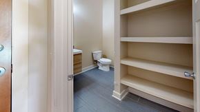 Macon apartment for rent - A white toilet is in a small room with a shelf.