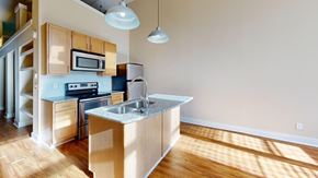Macon apartment for rent - A kitchen with wooden cabinets and a stainless steel sink.