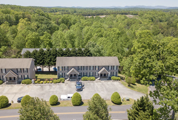 Cleveland apartment for rent - A large building surrounded by trees and a parking lot.