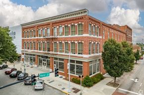 Macon apartment for rent - A street view of a red brick building with the sign "The Danner" on it.