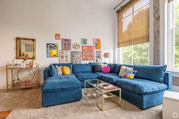 Macon apartment for rent - A living room with a blue couch and a coffee table.