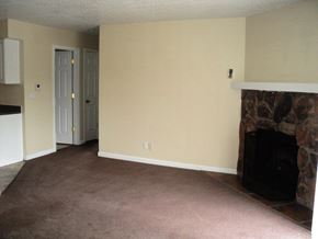 Newburgh apartment for rent - A living room with a fireplace and carpeted floor.