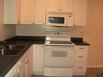Newburgh apartment for rent - A white oven and microwave above a white stove in a kitchen.