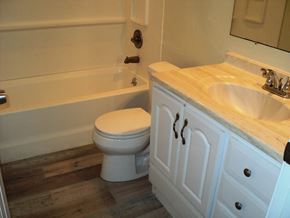 Newburgh apartment for rent - A white toilet sits next to a white sink in a bathroom.