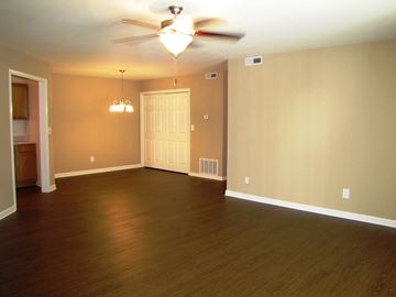 Evansville apartment for rent - an empty living room with wood floors and a ceiling fan