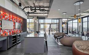 Chicago apartment for rent - A modern kitchen with a long counter and a person standing at the end.