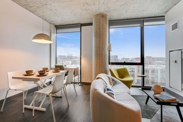 Chicago apartment for rent - A modern living room with a dining table and chairs.