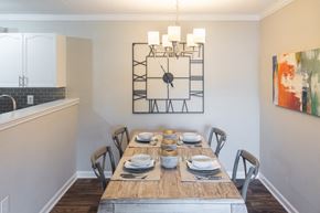 Auburn apartment for rent - A dining room with a wooden table set for a meal.
