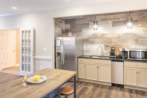 Auburn apartment for rent - A kitchen with a wooden table and a refrigerator.