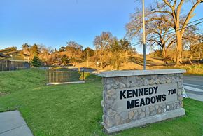Jackson apartment for rent - A stone sign that says Kennedy Meadows stands in a grassy area.