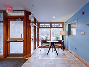 Portland apartment for rent - A view of a hallway with a table and chairs.