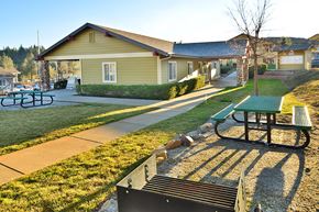 Grass Valley apartment for rent - A park with a picnic table and a bench in front of a building.