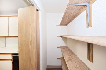 Twin Falls apartment for rent - A kitchen with wooden cabinets and shelves.