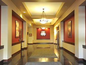 Portland apartment for rent - A hallway with a rug on the floor and a chandelier hanging from the ceiling.