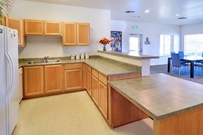Jackson apartment for rent - A kitchen with wooden cabinets and a white refrigerator.