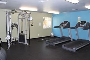 Perris apartment for rent - A gym with treadmills and a weight machine.
