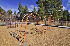 Truckee apartment for rent - A playground with orange swings and a purple slide.
