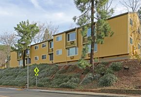 Auburn apartment for rent - A yellow building with a yellow sign in front of it.