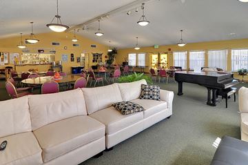 Truckee apartment for rent - A living room with a white couch and a black piano.