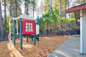 Grass Valley apartment for rent - A playground with a red and blue structure and a slide.