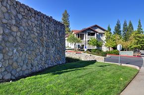 Grass Valley apartment for rent - A stone wall in front of a house.