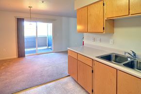 Grass Valley apartment for rent - A kitchen with wooden cabinets and a sink.
