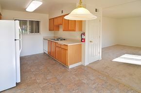 Grass Valley apartment for rent - A kitchen with wooden cabinets and a white refrigerator.