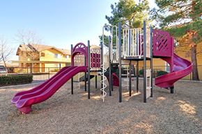 Oroville apartment for rent - A playground with a red slide and a purple slide.