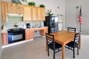 Lincoln apartment for rent - A kitchen with wooden cabinets and a black refrigerator.