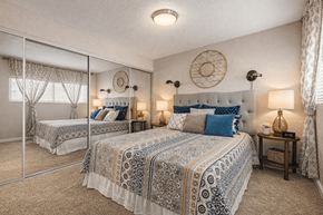 Euless apartment for rent - A bedroom with two beds and a mirror. at Infinity on the Landing Apartments , Texas