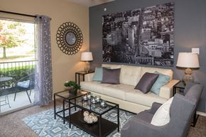Mesquite apartment for rent - A living room with a couch, chair, and a large picture on the wall at Infinity on Sunnyvale Apartments , Mesquite, TX, 75150