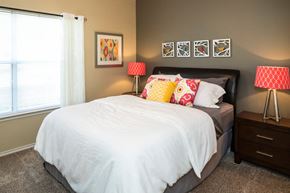 Mesquite apartment for rent - A bedroom with a white bed and two red and white lamps at Infinity on Sunnyvale Apartments , Mesquite, 75150
