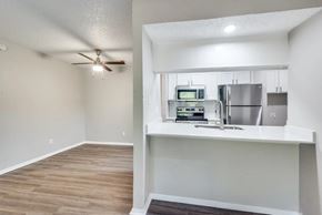 Dallas apartment for rent - A kitchen with a refrigerator, microwave, and oven at Infinity on the Oaks Apartments, Dallas 75231