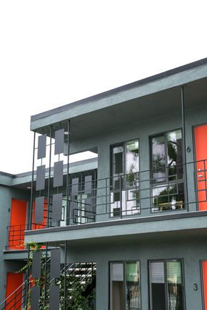 Los Angeles apartment for rent - A grey building with a red door and windows.