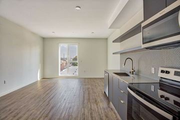 Los Angeles apartment for rent - A kitchen with a stove top oven and microwave.